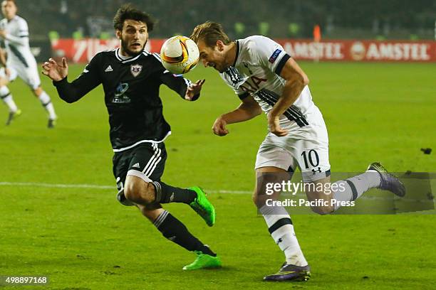 Badavi Guseynov of Qarabag FK is challenged by Harry Kane of Tottenham Hotspur FC during the UEFA Europe League match between Qarabag FK and...