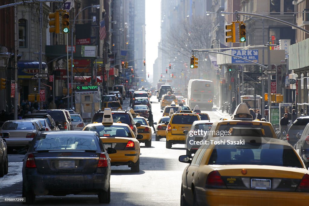 Winter sun illuminates Downtown Broadway traffic.