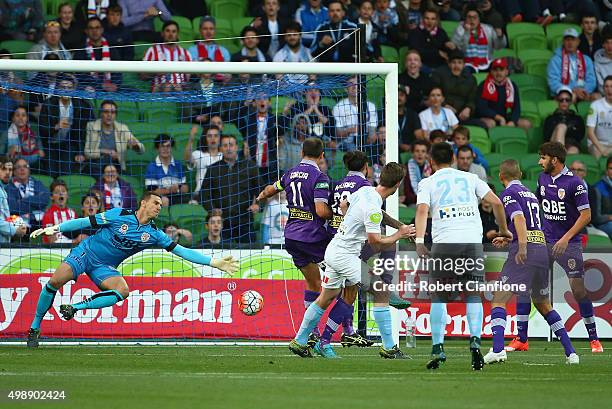 Connor Chapman of Melbourne City heads the ball past Perth Glory goalkeeper Ante Covic to score during the round eight A-League match between...