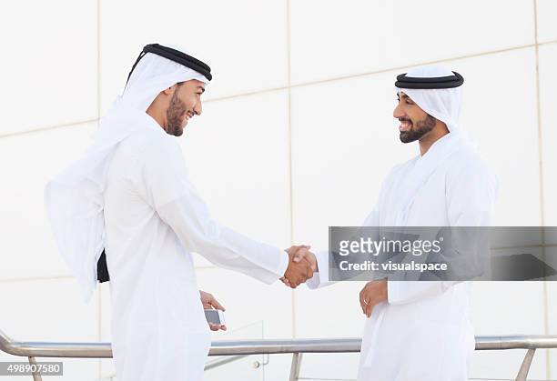 arab businessmen shaking hands - gulf countries stock pictures, royalty-free photos & images