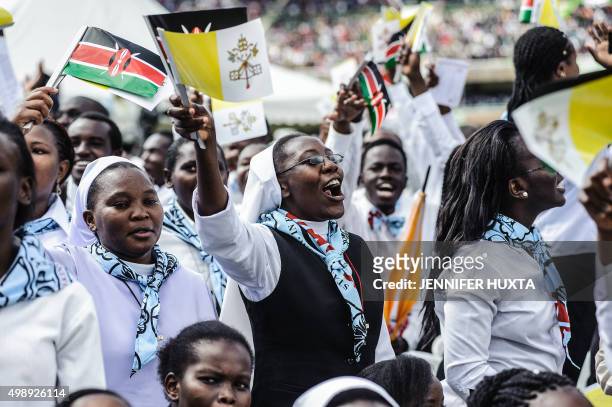 Kenyan faithful gather to welcome the Pope at the Kasarani Sports Stadium in Nairobi on November 27, 2015. Pope Francis lashed out at wealthy...