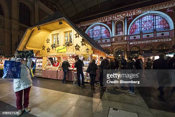 Shoppers queue at a festive food stall at a Christmas market at the main railway station in Zurich, Switzerland, on Thursday, Nov. 26, 2015. The...