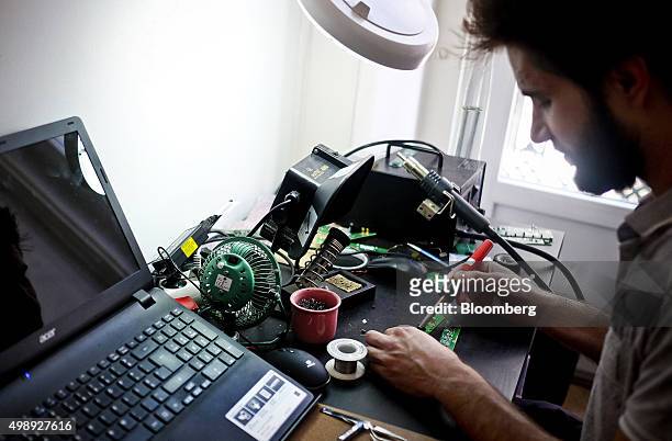 Technician solders a computer circuit board while using the workspace at the StartUp Lisboa Tech incubator for tech start-ups in Lisbon, Portugal, on...