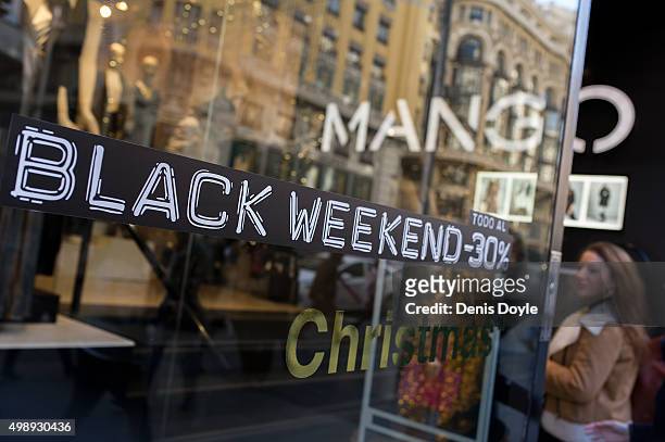 Shopper enters a Mango retail store advertising 'Black Friday' discounts on November 27, 2015 in Madrid, Spain. Originating in the USA as a sales day...