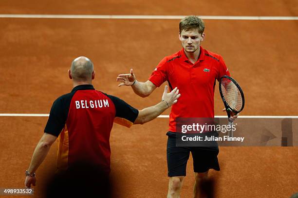 David Goffin of Belgium celebrates with Johan Van Herck the Captain of Belgium during the singles match against Kyle Edmund of Great Britain on day...