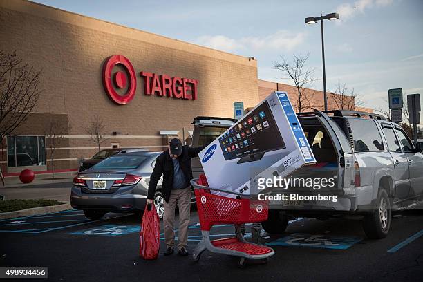 Customer prepares to load a Samsung Electronics Co. Television in their car outside of a Target Corp. Store in Jersey City, New Jersey, U.S., on...