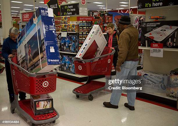 Customers push shopping carts loaded with televisions at a Target Corp. Store in Jersey City, New Jersey, U.S., on Friday, Nov. 27, 2015. In 2011,...