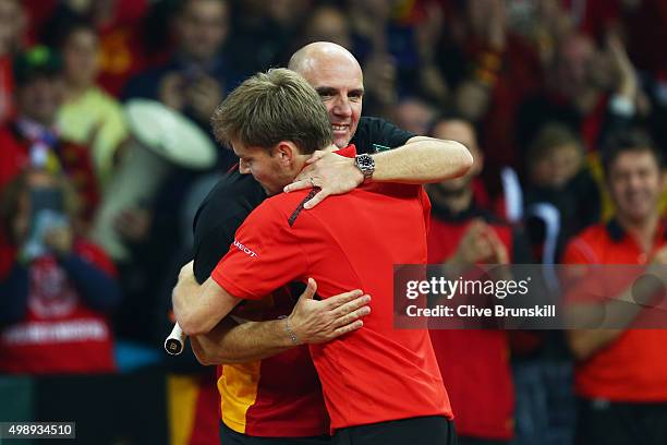 David Goffin of Belgium celebrates his victory with Johan Van Herck the Captain of Belgium during the singles match against Kyle Edmund of Great...