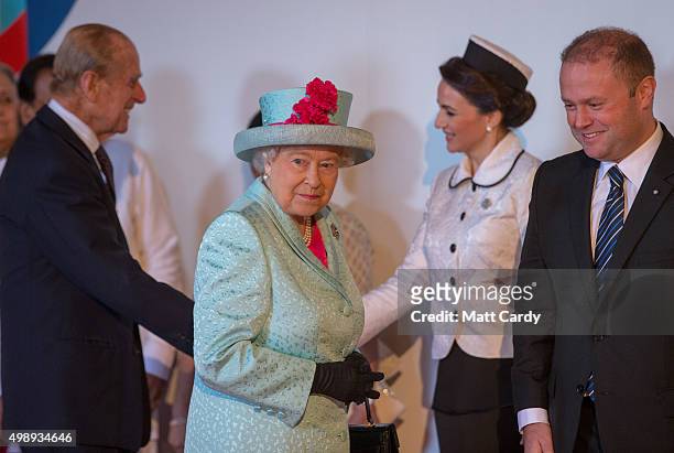 Queen Elizabeth II accompanied by Prince Philip, Duke of Edinburgh is greeted by Malta Prime Minister Joseph Muscat as they arrive at CHOGM opening...