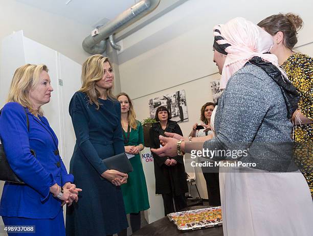 Queen Maxima of The Netherlands wearing a dress by Danish designer Claes Iversen and Education Minister Jet Bussemaker meet women during the "Kracht...