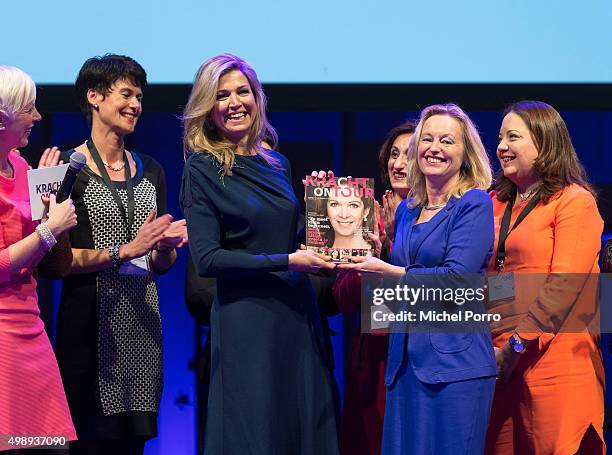 Queen Maxima of The Netherlands wearing a dress by Danish designer Claes Iversen receives the first copy of the Kracht on Tour Magazine from...