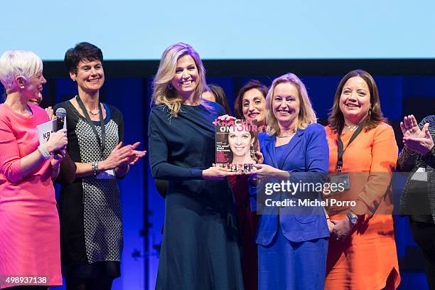 Queen Maxima of The Netherlands wearing a dress by Danish designer Claes Iversen receives the first copy of the Kracht on Tour Magazine from...