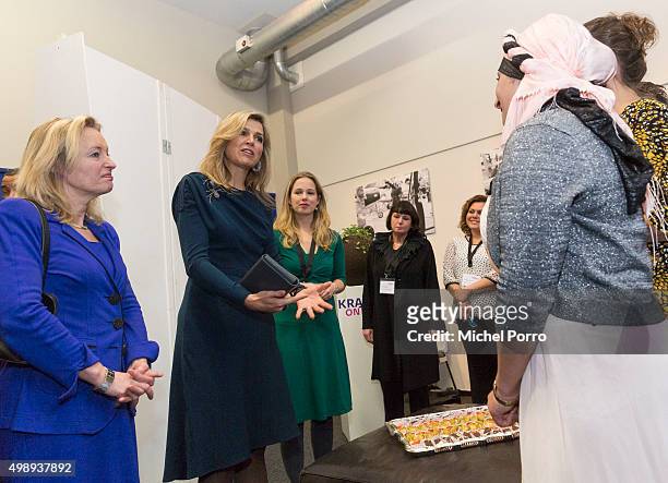 Queen Maxima of The Netherlands wearing a dress by Danish designer Claes Iversen and Education Minister Jet Bussemaker meets women during the "Kracht...