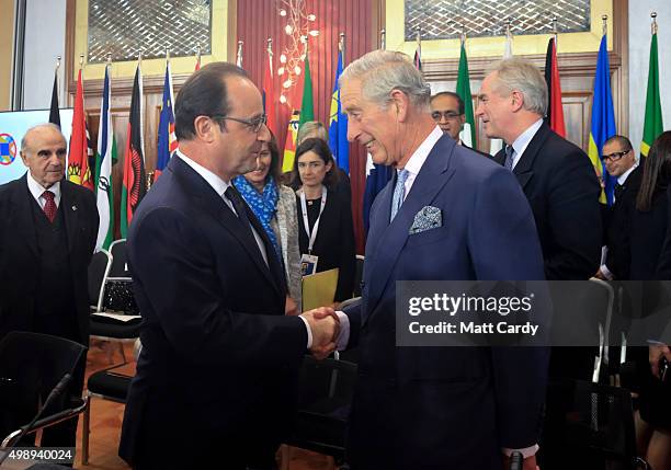 French President Francois Hollande is greeted by Prince Charles, Prince of Wales at a Special Executive Session on Climate Action being held at the...