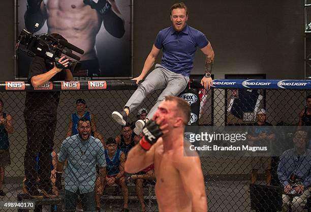 Head coach Conor McGregor jumps into the Octagon after Artem Lobov knocks out Chris Gruetzemacher during the filming of The Ultimate Fighter: Team...