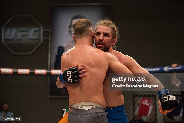 Artem Lobov hugs Chris Gruetzemacher after their fight during the filming of The Ultimate Fighter: Team McGregor vs Team Faber at the UFC TUF Gym on...