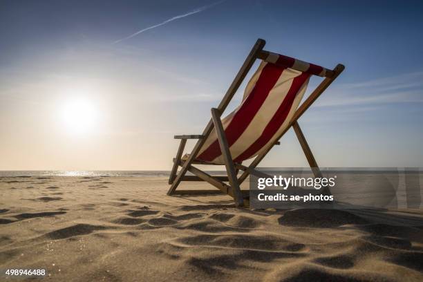 lounge chair on sunny day at beach - deckchair stock pictures, royalty-free photos & images