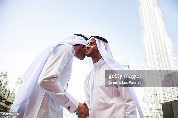 emirates business men downtown dubai - friends greeting stock pictures, royalty-free photos & images