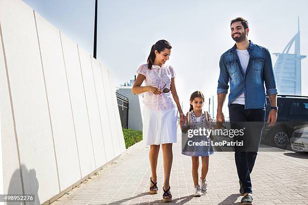 young family taking daughter to school - dubai family stock pictures, royalty-free photos & images