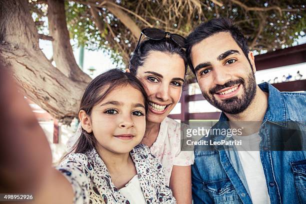 girl taking a selfie with parents - arabic style stock pictures, royalty-free photos & images