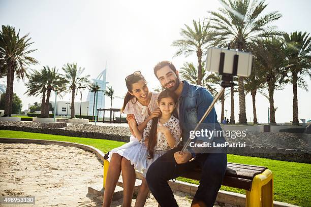 girl taking a selfie with parents - dubai fun stock pictures, royalty-free photos & images