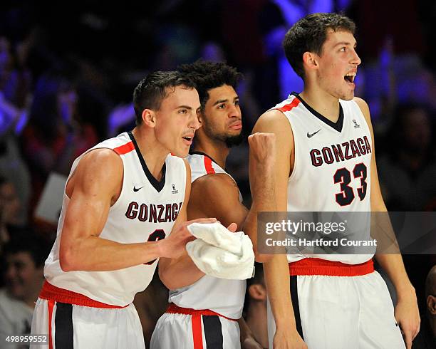 Gonzaga Bulldogs players Kyle Dranginis , Josh Perkins and Kyle Wiltjer react to a made Gonzaga basket during the third/fourth place game of the...