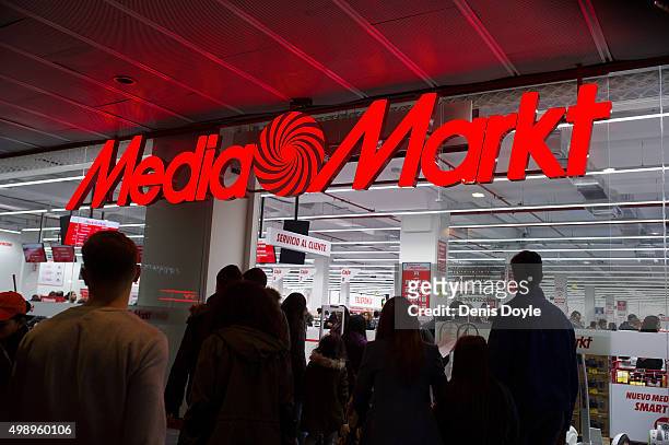 People enter a store of the consumer electronics company Media Markt during 'Black Friday' discounts on November 27, 2015 in Madrid, Spain....
