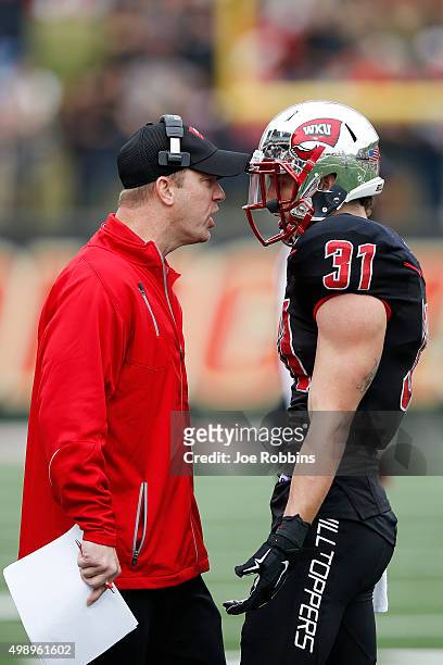 Head coach Jeff Brohm of the Western Kentucky Hilltoppers yells at Branden Leston after he was called for a penalty against the Marshall Thundering...