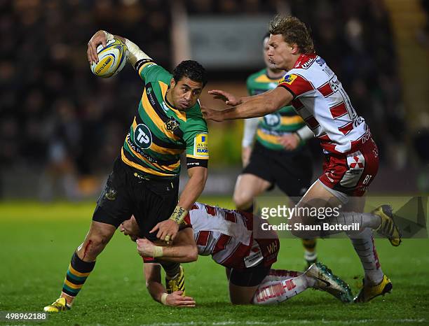 George Pisi of Northampton Saints is tackled by Willi Heinz and Billy Twelvetrees of Gloucester Rugby during the Aviva Premiership match between...
