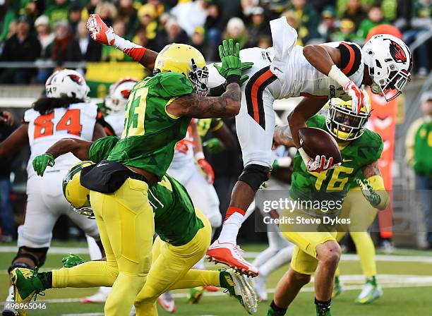 Quarterback Seth Collins of the Oregon State Beavers leaps over defensive back Charles Nelson of the Oregon Ducks for a touchdown during the third...