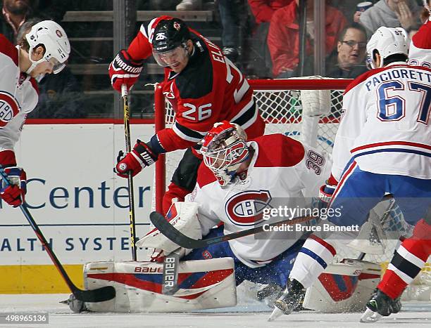 Patrik Elias of the New Jersey Devils gets in behind Mike Condon of the Montreal Canadiens during the first period at the Prudential Center on...