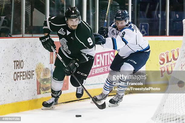 Yan Pavel Laplante of the Gatineau Olympiques controls the puck behind the net against Garrett Johnston of the Chicoutimi Sagueneens on November 27,...