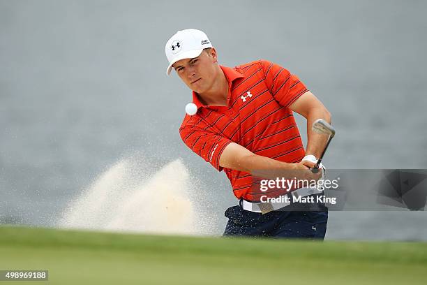 Jordan Spieth of the United States plays out of the bunker on the 4th hole during day three of the 2015 Australian Open at The Australian Golf Club...