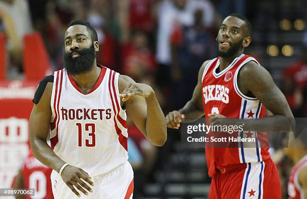 James Harden of the Houston Rockets celebrates after a three-point shot as JaKarr Sampson of the Philadelphia 76ers looks on during their game at the...