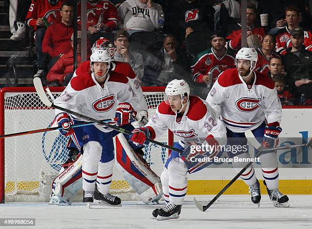 Tom Gilbert, Brian Flynn and Greg Pateryn of the Montreal Canadiens skate against the New Jersey Devils at the Prudential Center on November 27, 2015...