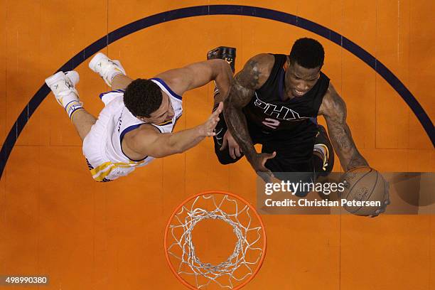 Eric Bledsoe of the Phoenix Suns lays up a shot past Klay Thompson of the Golden State Warriors during the first half of the NBA game at Talking...