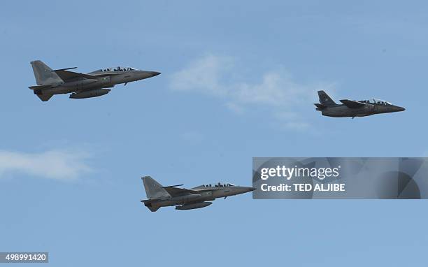 Pair of South Korean-made FA-50 multirole light fighter aircraft for the Philippine Air Force fly in formation with a Philippine Air Force Aermacchi...