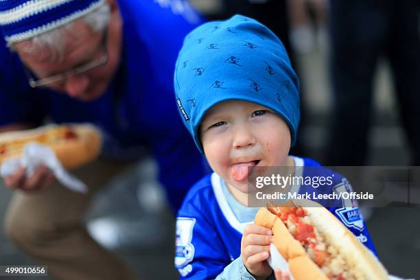 Young Everton fan enjoys a hot dog before the Barclays Premier League match between Everton and Liverpool at Goodison Park on October 4, 2015 in...