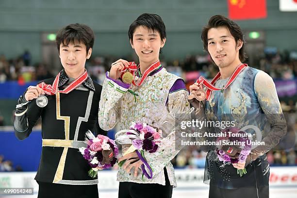 Boyang Jin of China , Yuzuru Hanyu of Japan and Takahito Mura of Japan pose woth thier medals duringthe day two of the NHK Trophy ISU Grand Prix of...