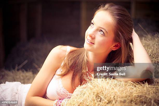 girl resting on hay - girl with brown hair stock pictures, royalty-free photos & images