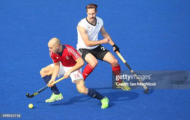Nick Catlin of Great Britain vies with Richard Hildreth of Canada during the match between Great Britain and Canada on day two of The Hero Hockey...