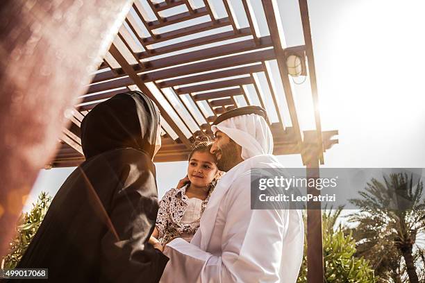 traditional emirati young family enjoying weekend - middle eastern culture stock pictures, royalty-free photos & images