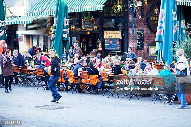 many people sitting outside of bar in dortmund - dortmund stad stockfoto's en -beelden
