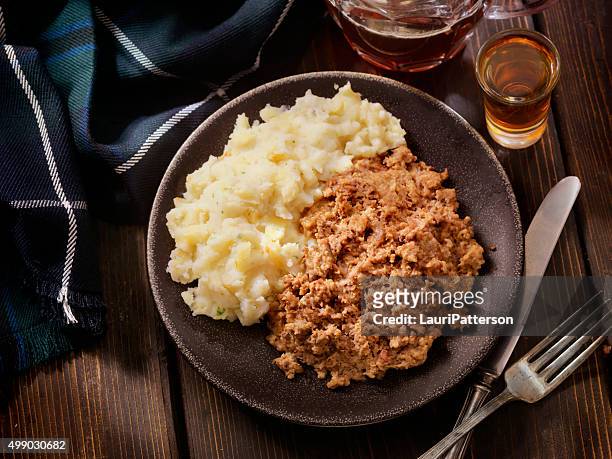 traditional haggis and neeps with whiskey and a beer - haggis stock pictures, royalty-free photos & images