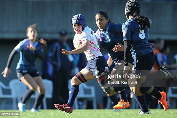 Yoko Suzuki of Japan runs with the ball during the World Sevens Asia Olympic Qualification match between Japan and Guam at Prince Chichibu Stadium on...