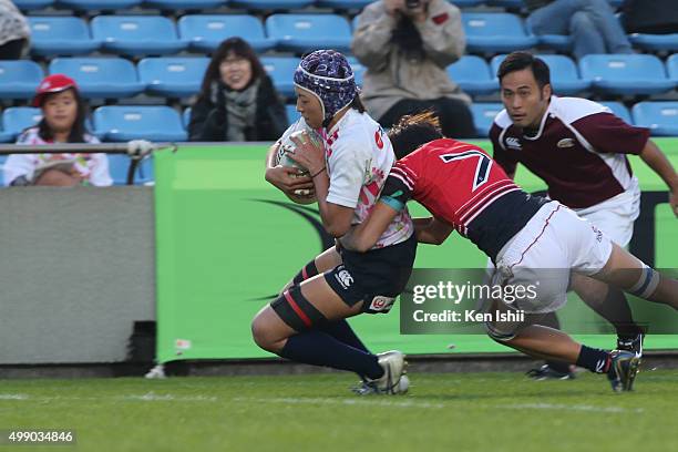 Chisato Yoko of Japan scores during the World Sevens Asia Olympic Qualification match between Japan and Hong Kong at Prince Chichibu Stadium on...
