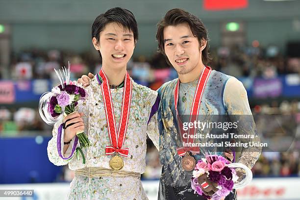 Yuzuru Hanyu of Japan and Takahito Mura of Japan pose with medals during the day two of the NHK Trophy ISU Grand Prix of Figure Skating 2015 at the...