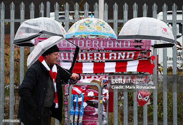 Merchandise seller hides from the wind and rain ahead of the Barclays Premier League match between Sunderland AFC and Stoke City FC at the Stadium of...