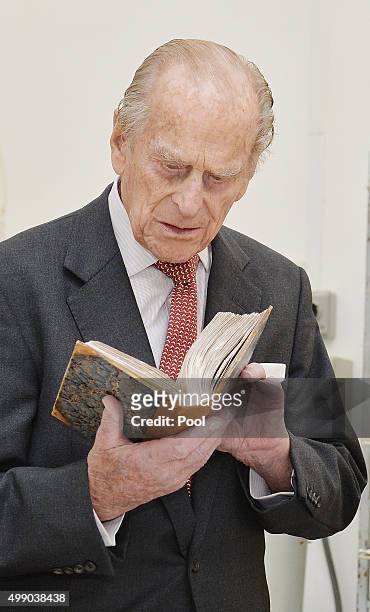 Prince Philip, Duke of Edinburgh is shown some rare 17th century Shakespeare books which have been restored at the Kalkara Heritage site on November...