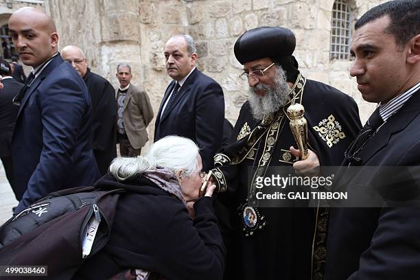 Pilgrim kisses the cross of Egyptian Coptic Pope Tawadros II after the funeral of Archbishop Anba Abraham, the head of the Coptic Church in the Holy...